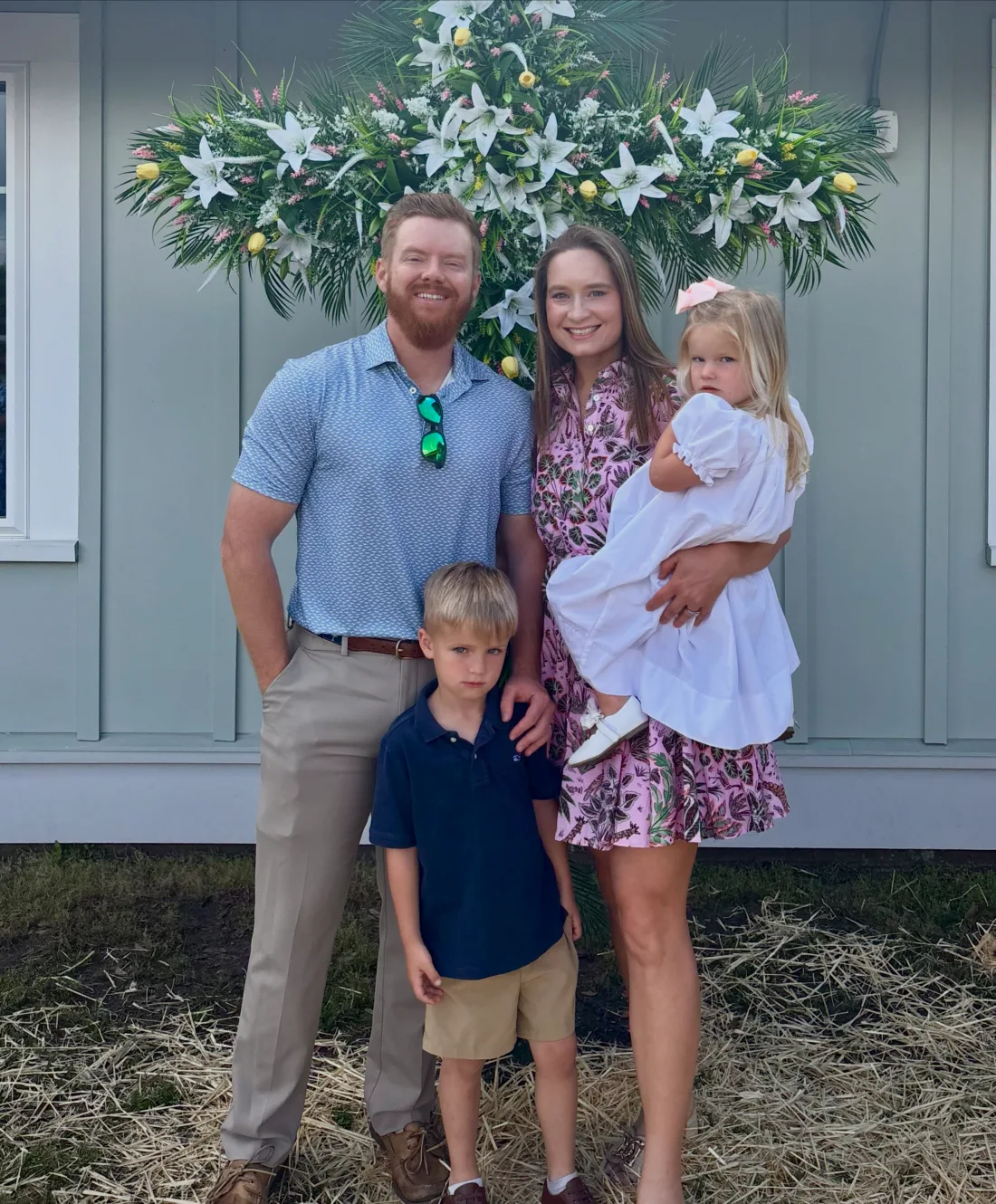 Pat Webster with his family in front of a floral display