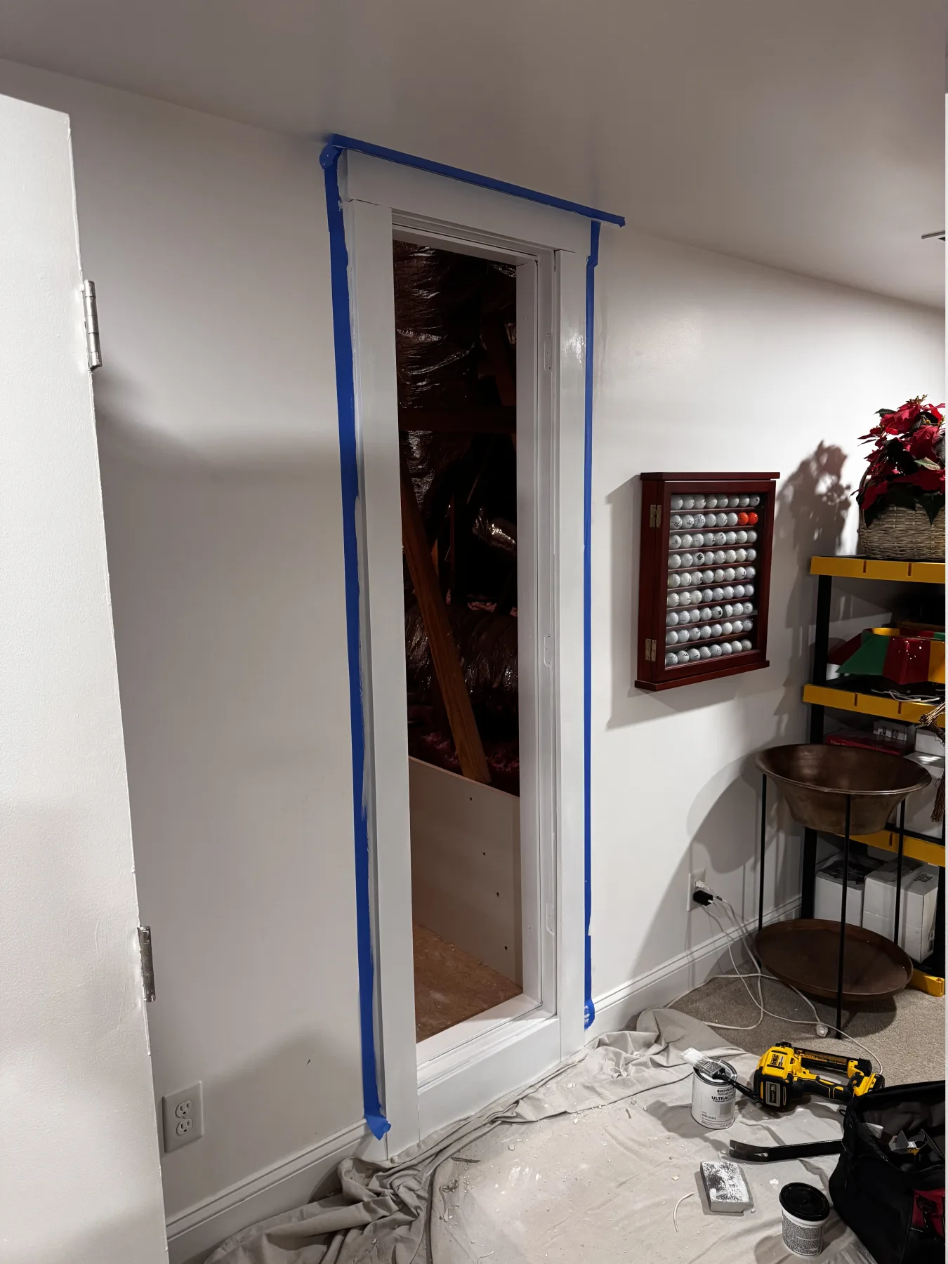 Attic access door after fresh trim, paint, and cleanup