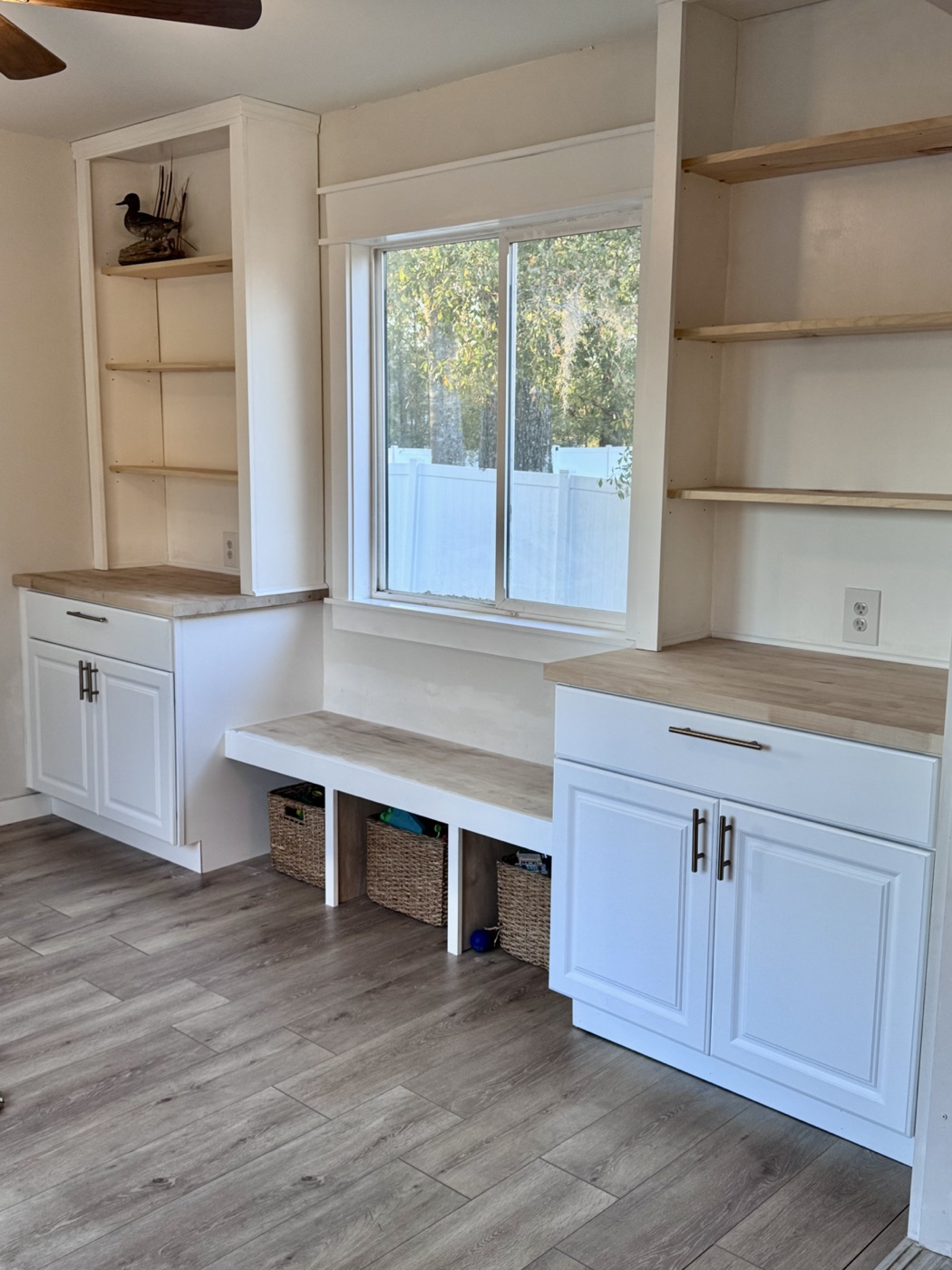 Finished custom built-ins with lower cabinets and window bench