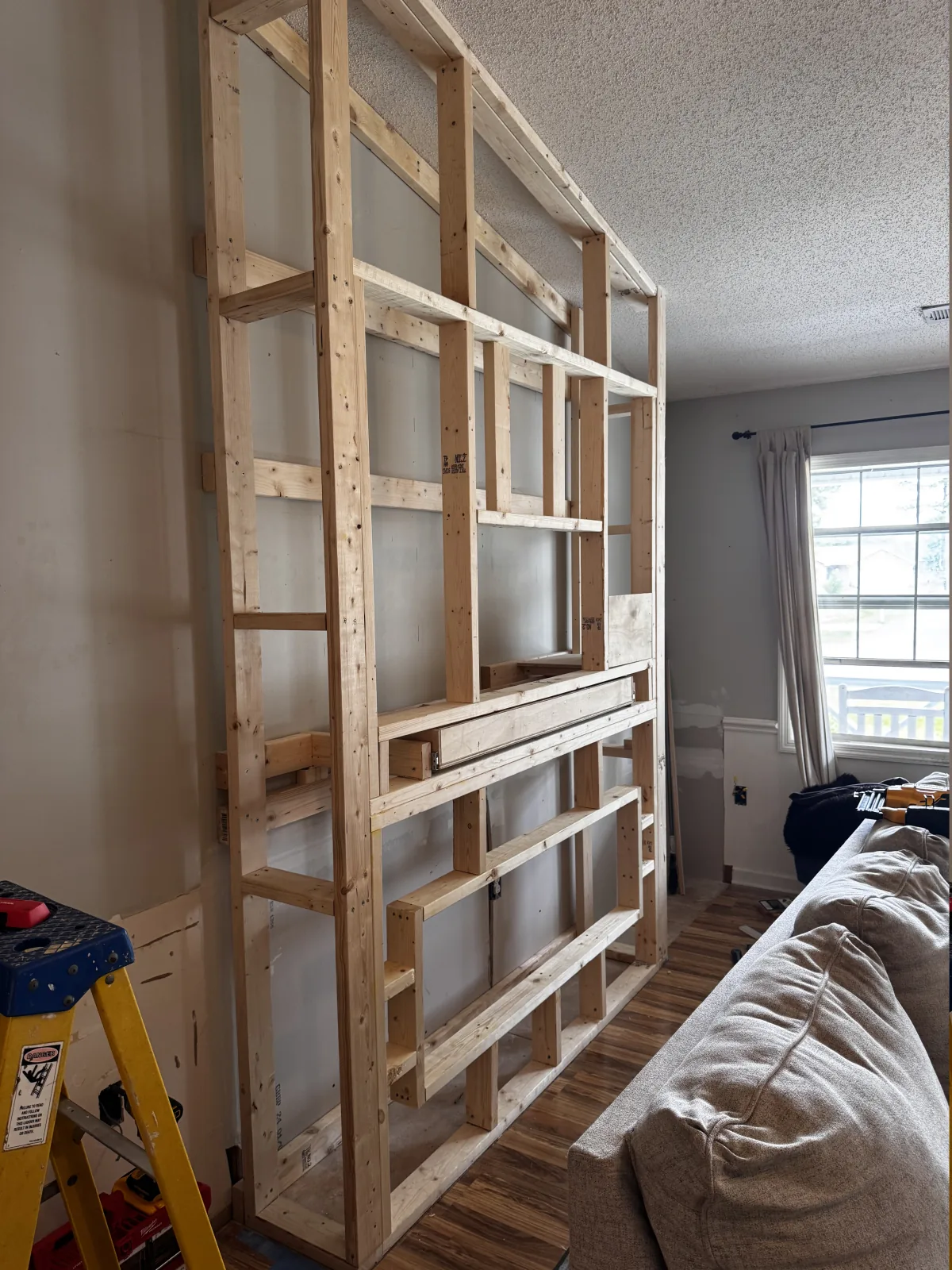 Wood framing for a custom floor-to-ceiling fireplace built-in