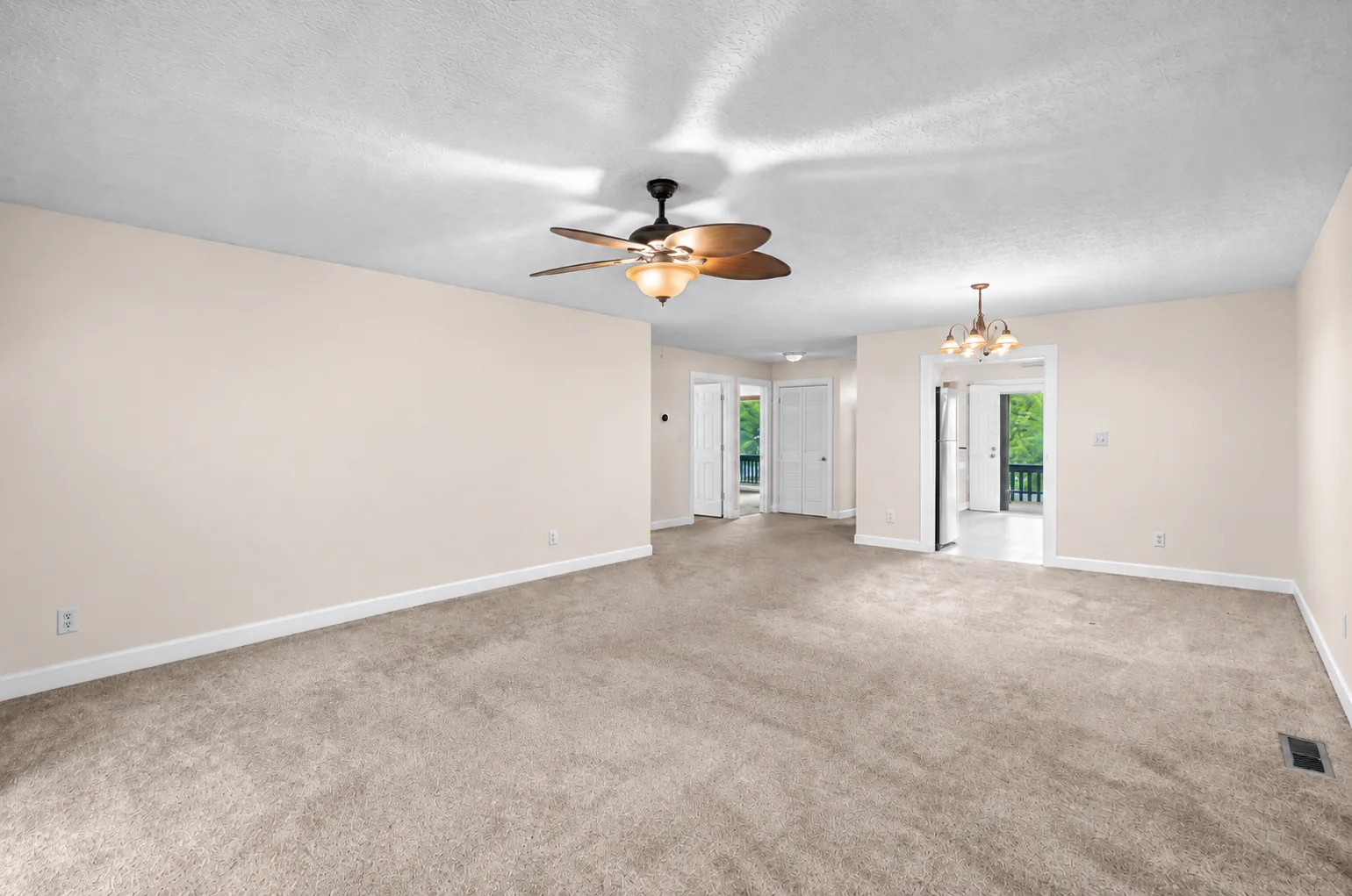 Freshly painted open living room with clean walls, ceiling, and white trim