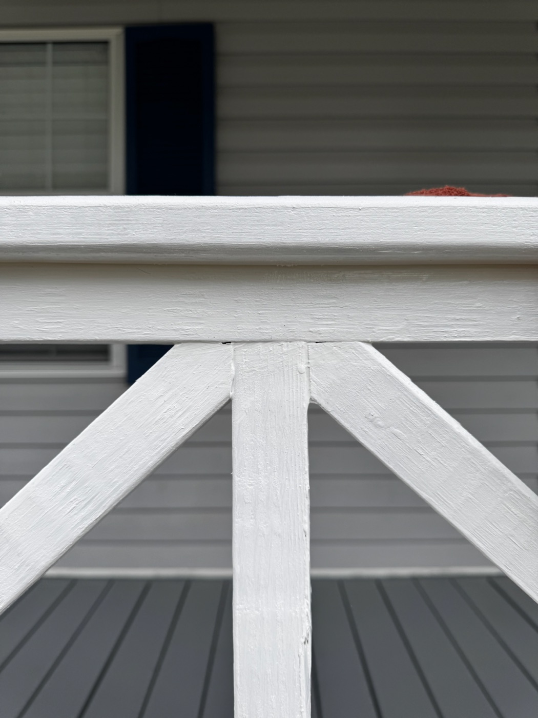 Close detail of painted porch railing and stair trim