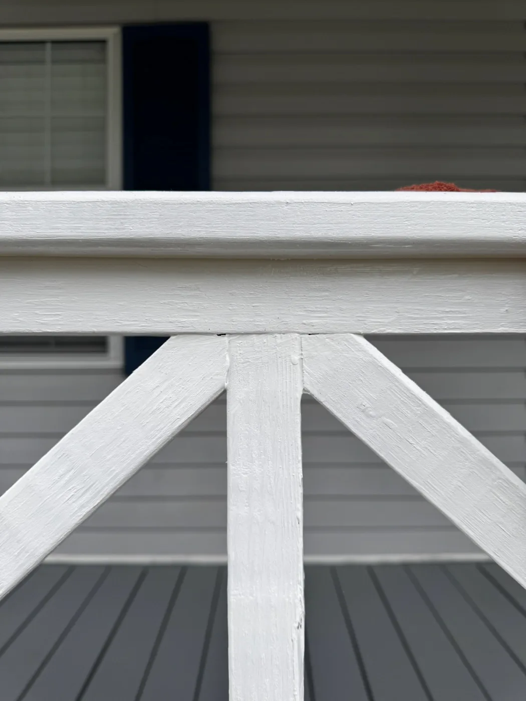Close detail of painted porch railing and stair trim