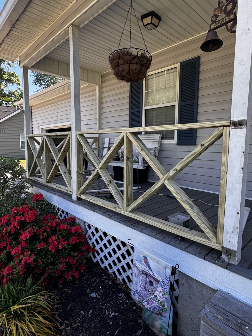 Porch railing project with custom wood cross-brace detail