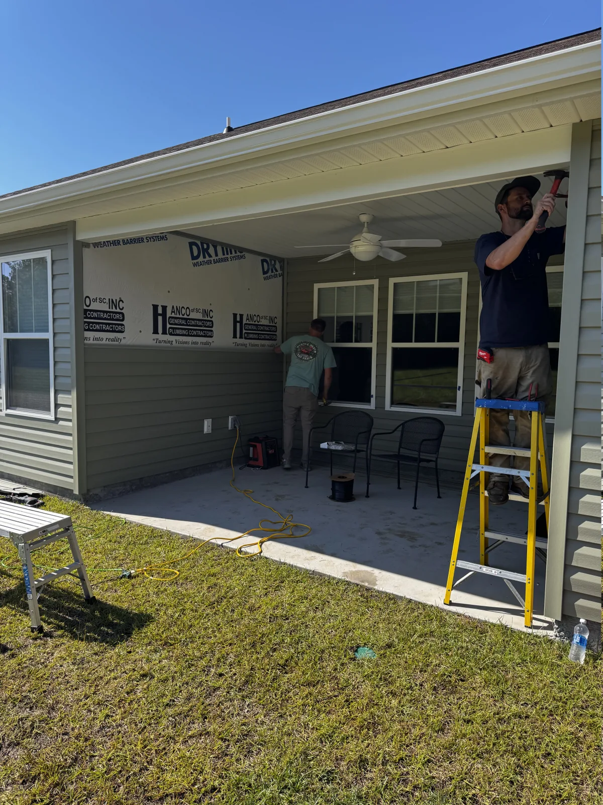 Exterior porch trim and screen framing being installed