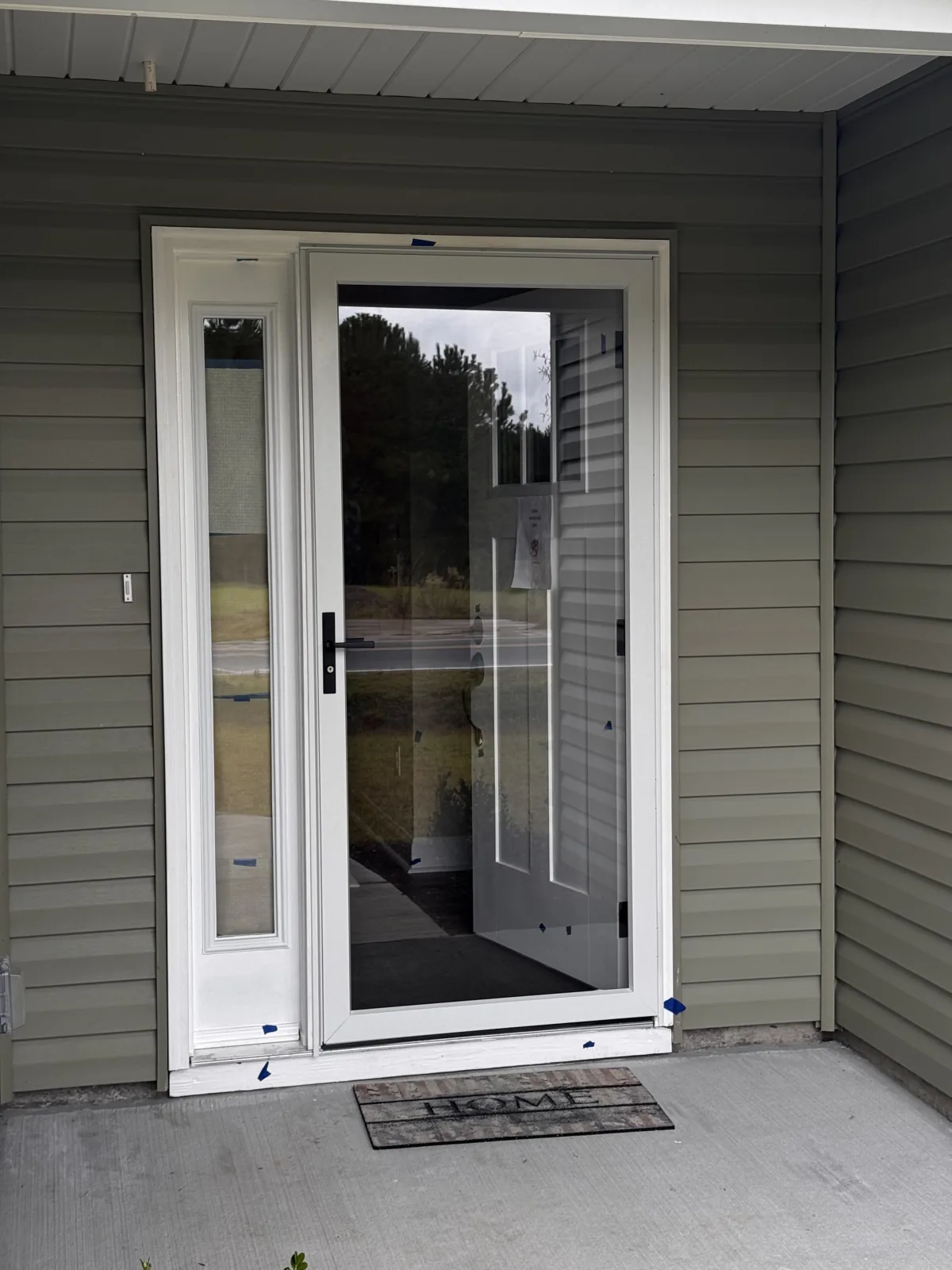 Full-view storm door installed at a covered porch entry